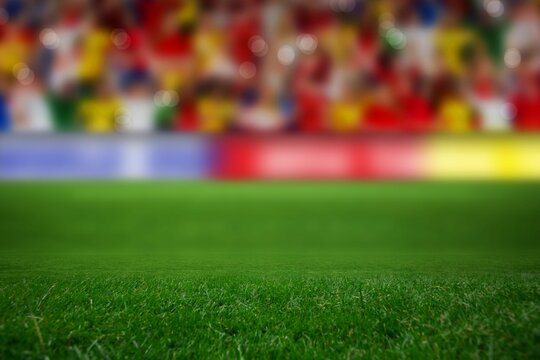 Grass soccer turf is being shown in flat design stadium with blurred spectators, advertising boards