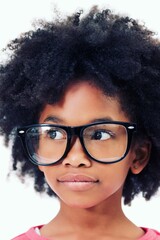 Close up of thoughtful girl with frizzy hair wearing big glasses