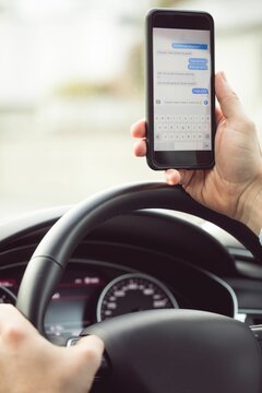 Fototapeta Man driver using smart phone in car, Write message