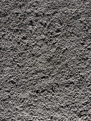 Rough cement surface displays raw texture and unfinished character, commonly seen in industrial...