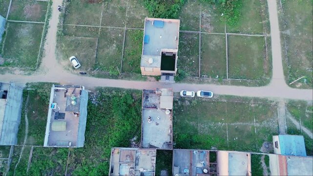 Aerial view highlights open plots and scattered houses
