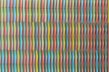 Colorful ceramic wall with vertical stripes forming abstract architectural texture