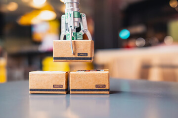 A robotic arm is picking up a tiny parcel box and lifting it up. The idea is to use AI and...