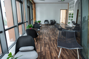 Contemporary Office Space Featuring Stylish Seating and Natural Light for Creative Collaboration