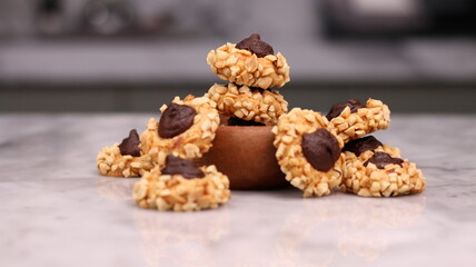 Cheese Peanut Chocolate in the photo on a marble table and small wooden bowl and mesh pan