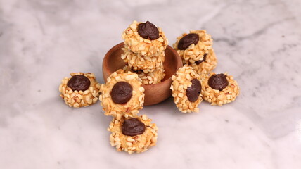 Cheese Peanut Chocolate in the photo on a marble table and small wooden bowl and mesh pan