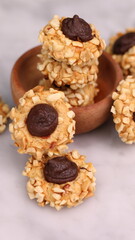 Cheese Peanut Chocolate in the photo on a marble table and small wooden bowl and mesh pan