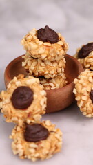 Cheese Peanut Chocolate in the photo on a marble table and small wooden bowl and mesh pan