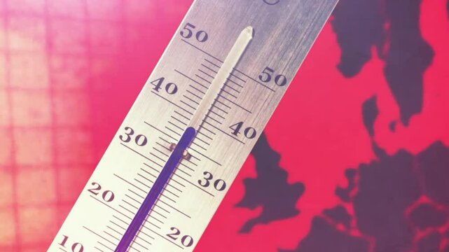 Thermometer and map of Europe in reddish colors symbolize climate change and a heat wave	