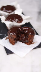 chocolate cake wrapped in cake paper with chocolate glaze topping