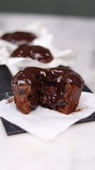 chocolate cake wrapped in cake paper with chocolate glaze topping