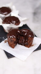 chocolate cake wrapped in cake paper with chocolate glaze topping