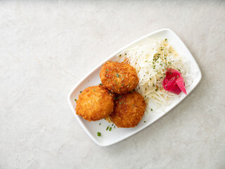 croquettes and cabbage salad on a plate