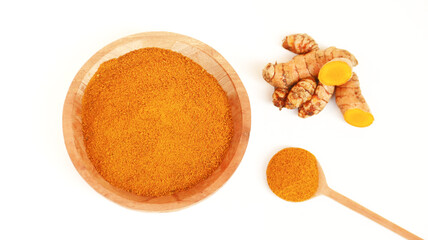 Turmeric powder or Kunyit bubuk, served in wooden bowl, copy space.