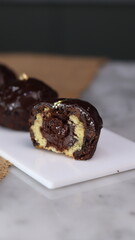 three cakes with frosted and gold chocolate topping and crunchy chocolate filling