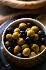 Green and Black Olives.This close-up features vibrant green and rich black olives, perfect for...