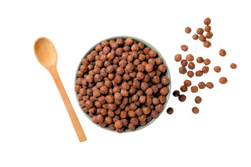 Chocolate cereal in bowl with spoon nearby, isolated on white, PNG