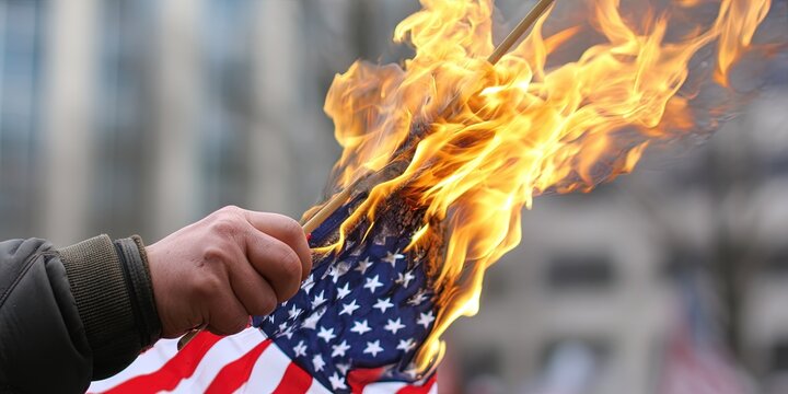 photo of angry protestor burning american flag - Powered by Adobe