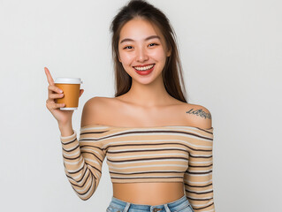 Happy Young Woman in Striped Top Presenting Coffee Cup – Studio Portrait with White Background for Advertising, Branding, or Promotional Use