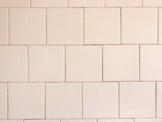 Naklejka premium A white tiled wall with a white brick pattern