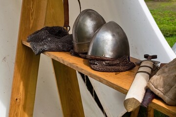 Medieval Armor and Weapons Display Outdoors. Reenactment Gear with Axe and Helmets. Viking Style...