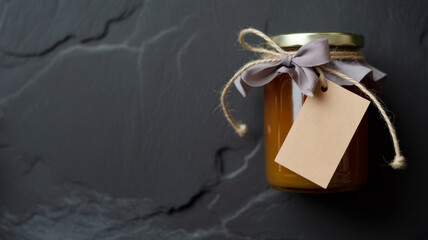 Artisanal Jam Jar with Tag and Ribbon on Dark Stone Surface Still Life