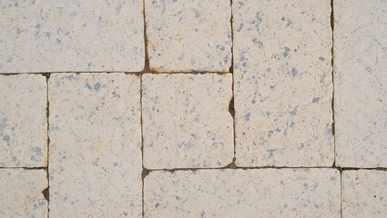 Fototapeta premium Beige stone paving slabs create a classic outdoor floor.
