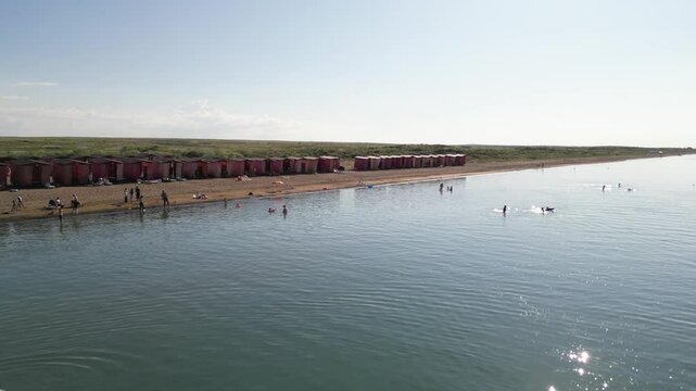 A coastline with a sandy beach. Lake Balkhash. Relaxing by the water, swimming and water activities. The view from the drone.