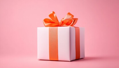 Obraz premium White gift box with orange ribbon bow on pink background (1)