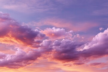 Obraz premium Clouds fill the sky painted in hues of purple pink and orange creating a dreamy skyscape