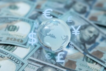 A globe surrounded by various international currency symbols. Global finance, foreign exchange,...