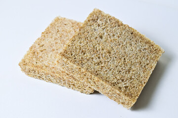 Side view of two whole wheat slices breads with abstract product background. Isolated on white. Clipping path. pile, stack. close up.