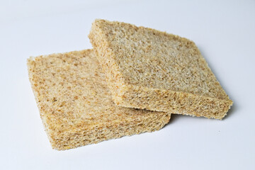 Side view of two whole wheat slices breads with abstract product background. Isolated on white. Clipping path. pile, stack. close up.