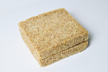 Close up view of two whole wheat slices bread with abstract product background. Isolated on white. Clipping path. pile, stack.