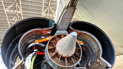 Rear view of a large aircraft engine during installation in the hangar. Common nozzle assembly