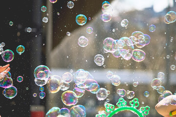 Children's festival activity idea concept. Cluster of colorful soap bubbles or ballon flying....