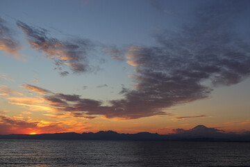 A scenic view of a sunrise or sunset, with warm tones painting the sky. Perfect for use as...