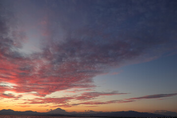 A scenic view of a sunrise or sunset, with warm tones painting the sky. Perfect for use as...