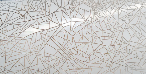 Cracked and peeling white plastic surface with intricate fracture patterns