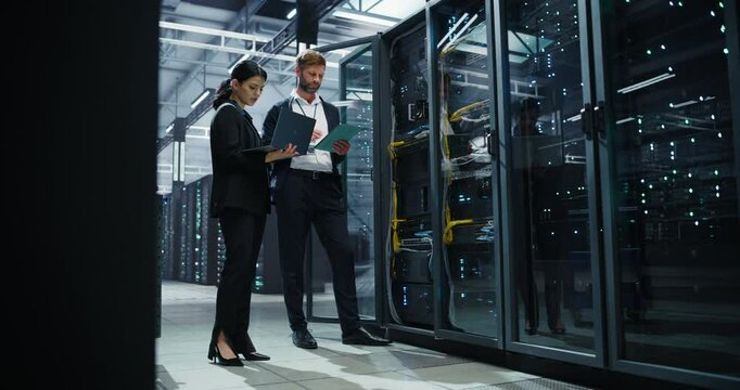 In a Modern Data Center, Male Data Scientist and Female AI Specialist Analyze Algorithms on a Laptop and Tablet Computers. Specialists Exploring Machine Learning Systems for Large Language Models
