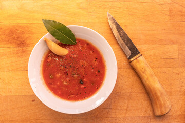 Tomato Soup Decorated with Knife and Bay Leaf – Rustic and Elegant Presentation