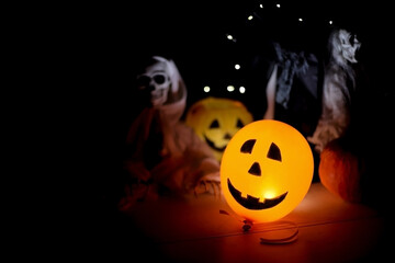Halloween Scene with Glowing Balloon and Skeleton Decorations on Dark Background