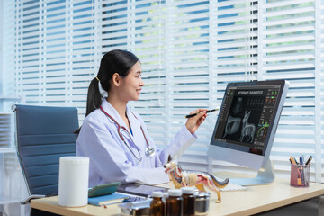 A confident Asian female veterinarian sits at her desk, providing online consultations. She uses computer and monitor to diagnose and advise pet owners, offering virtual care through  animal clinic.