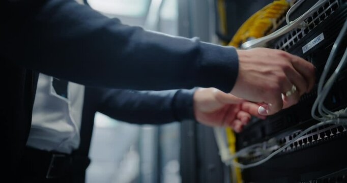 AI Server System Administrator Inserting Additional Hard Drive Storage Units and Bringing Upgraded Cloud Computing Supercomputer Online. Anonymous Male Specialist Working in a Modern Data Center