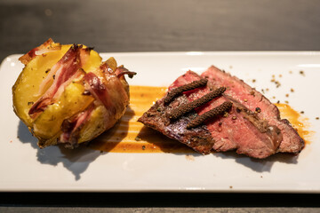 Grilled Medium-Rare Steak with Baked Potato and Crispy Bacon – Hearty BBQ Meal