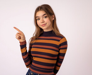Smiling Woman in Striped Shirt Pointing Up – Studio Portrait with White Background, Perfect for Advertising, Branding, or Marketing Campaigns