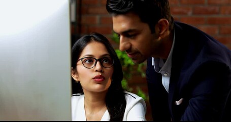Indian business people using computer in office for project discussion, closeup of Asian corporate man and woman in professional attire collaborating on computer in cozy modern office interior - Powered by Adobe