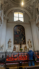 Serene Church Interior with Lit Candles & Baroque Architecture