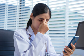 A confident Asian female veterinarian at her animal clinic feels stressed and overwhelmed by office...