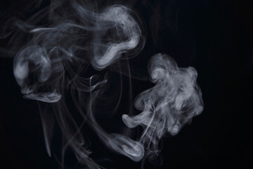 White Smoke Swirls on Black Background for Composite Use
